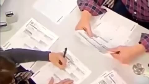 2020 poll worker filling in empty ballots