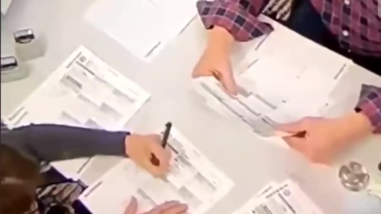 2020 poll worker filling in empty ballots