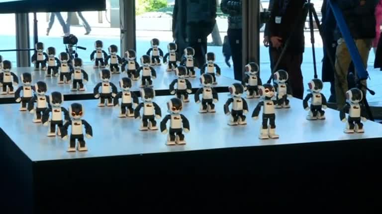 Robots dance in mass-games fashion