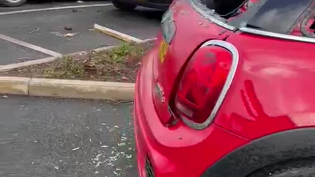 Aftermath of Storm Causing Roof to Land on Cars in Parking Lot