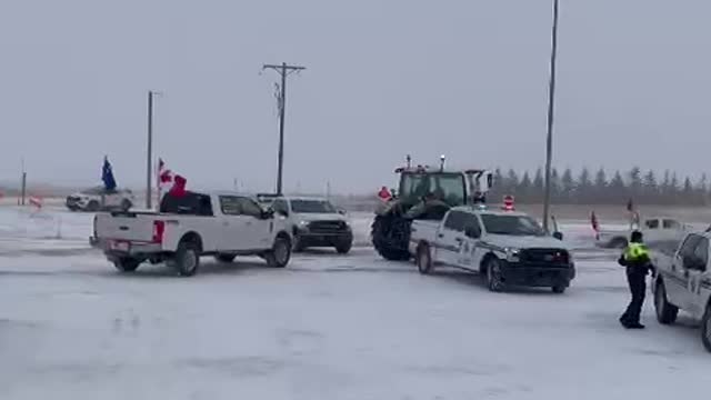 Farmers break through RCMP barricades setup near Coutts, Alberta to support blockade.