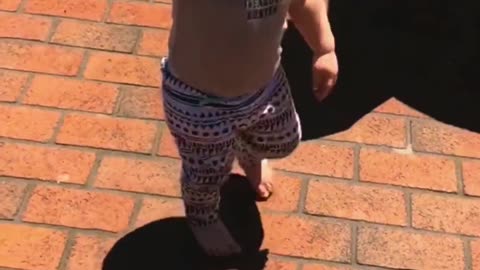 Baby running away from her shadow