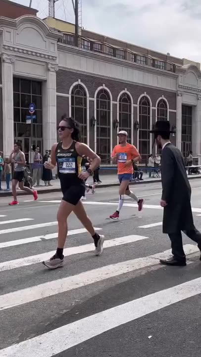 People trying to cross the street during the NYC Marathon