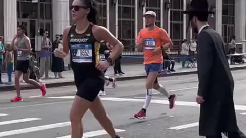 People trying to cross the street during the NYC Marathon