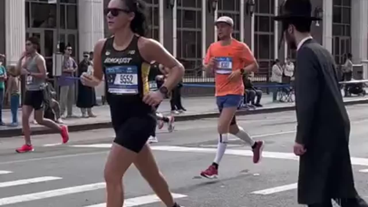 People trying to cross the street during the NYC Marathon