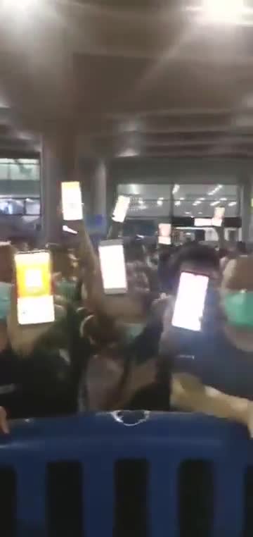 Chinese holding COVID yellow/red tag on their phone