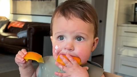 Baby eating fully moment