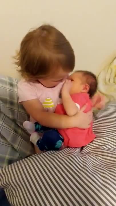 Big sister yells, " Get her a binky."