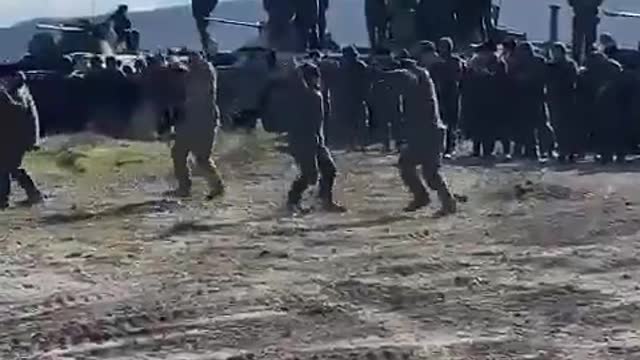 Russian troops celebrating with Ukrainian locals who are welcoming the Russian army as peacekeepers