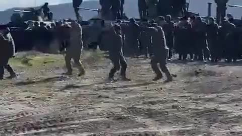 Russian troops celebrating with Ukrainian locals who are welcoming the Russian army as peacekeepers