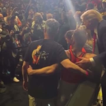 Wrestlers walk over to shake President Trump’s hand