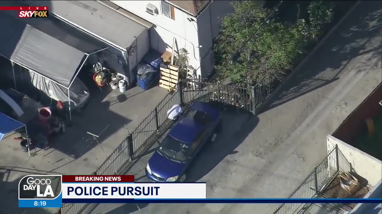 'Come on guys! He's right there!': Pursuit suspect tries to evade LAPD by laying next to vehicle
