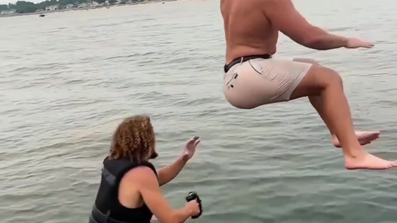 "Unexpected Splash: Man Takes a Dive into the Sea"