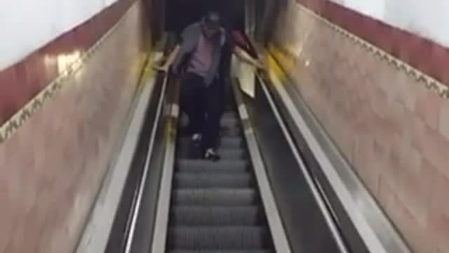 Man falls on escalator