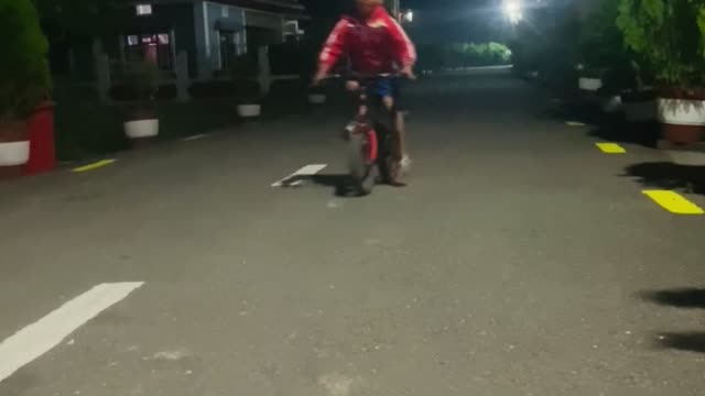 Cute boy showing cycle stunt