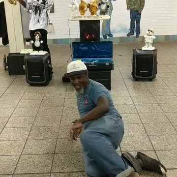 Man in blue shirt jeans dancing subway station