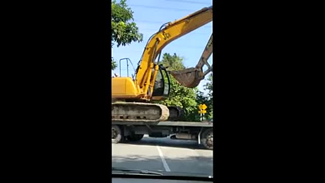 Bulldozer climbing onto a truck