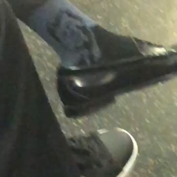Man wearing blue john f kennedy socks on train