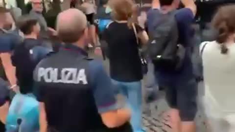 Police in Florence, Italy, march with protesters at the anti covid passport demo