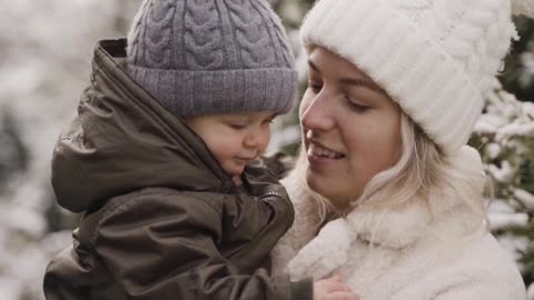 A Woman Kissing and Playing with her Baby