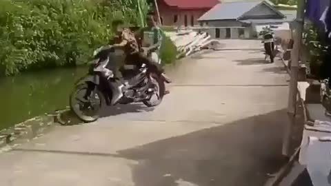 boy riding a motorbike makes others laugh