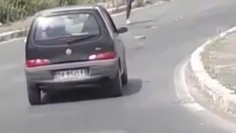 Bored African throws stones at cars in Rome