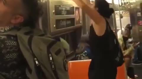 New York woman tears down "propaganda" ads in a train