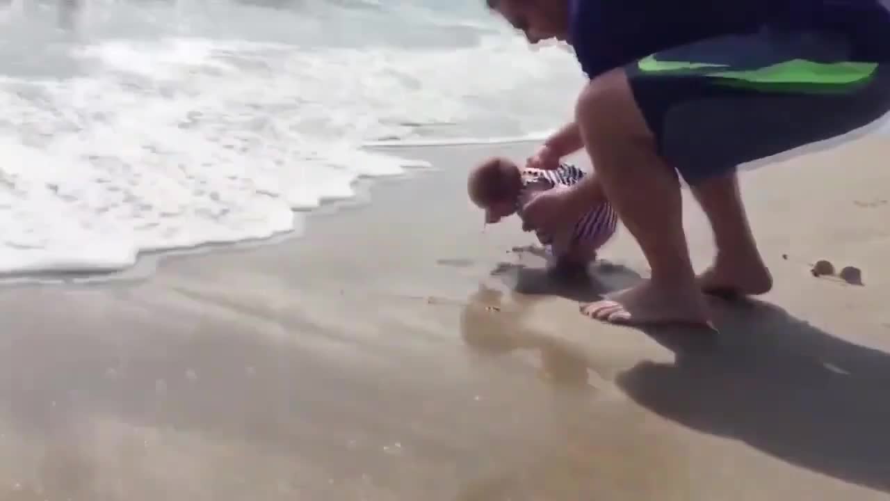 CHILDREN HAVING FUN ON THE BEACH 2