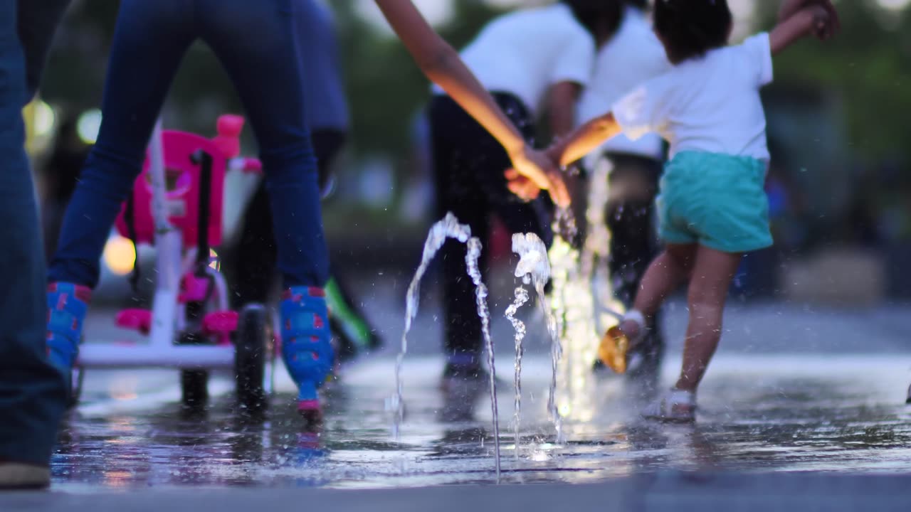 Children playing with a dancing fountain