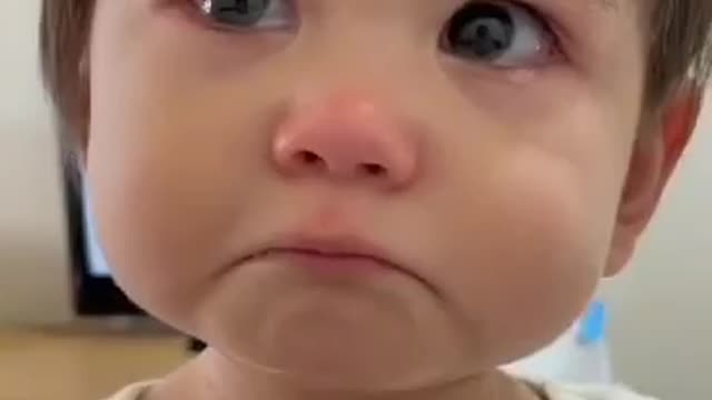 Cute baby boy try to express his emotions