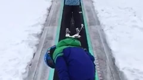 Kid in blue falls off ski belt