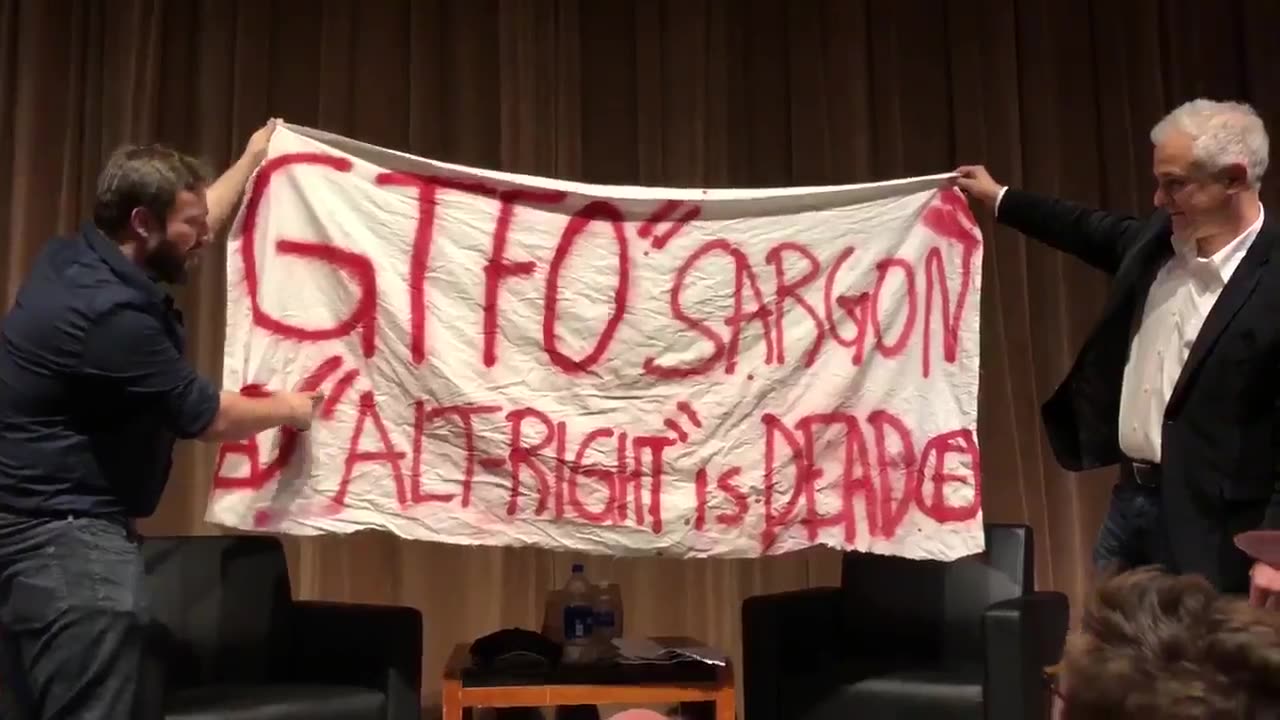 may 2018 Sargon and Peter Boghossian hold up banner found outside later someone pulls fire alarm