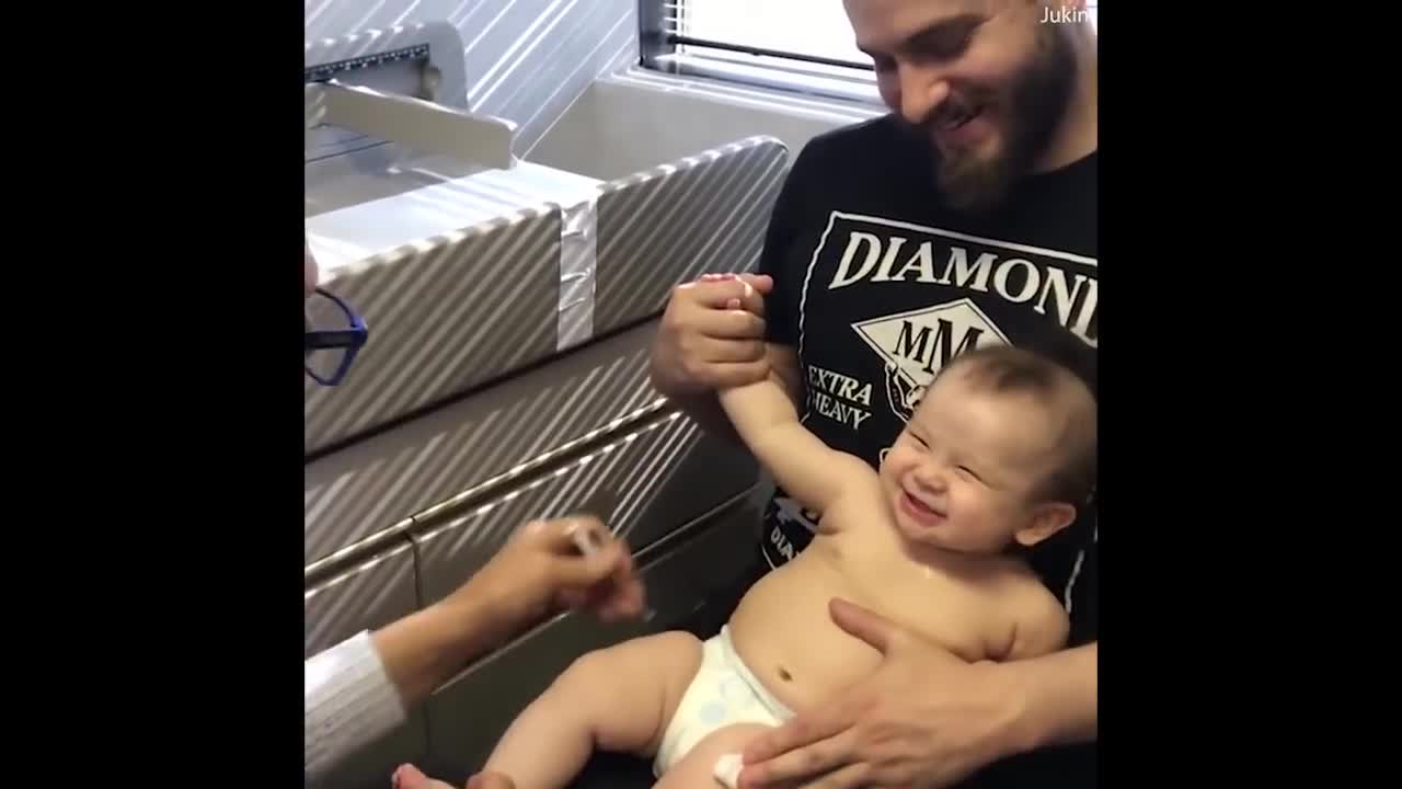 Doctor distracts baby from her shots with goofy tune