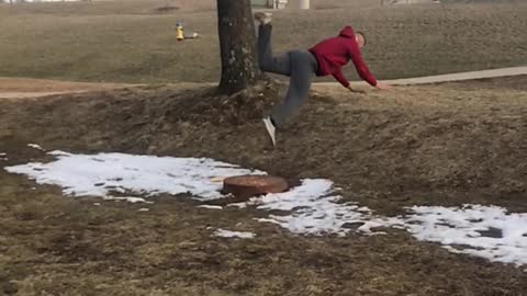 Guy slips in mud and does a front flips into grass