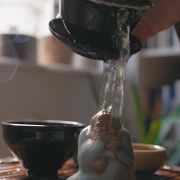 Pouring Hot Tea on a Statue