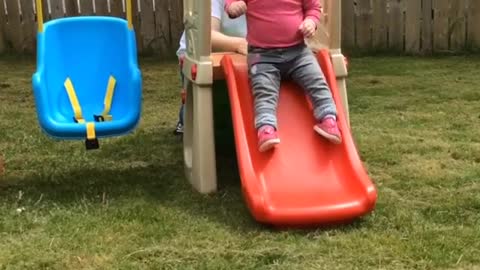 Baby faceplants off slide