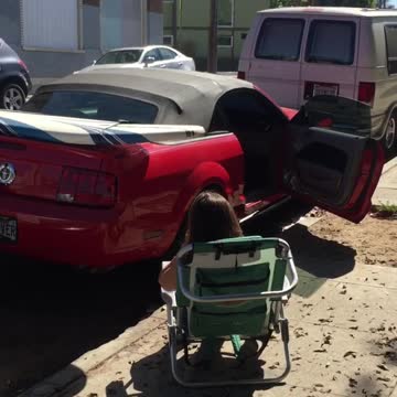 White surf board on top of red car