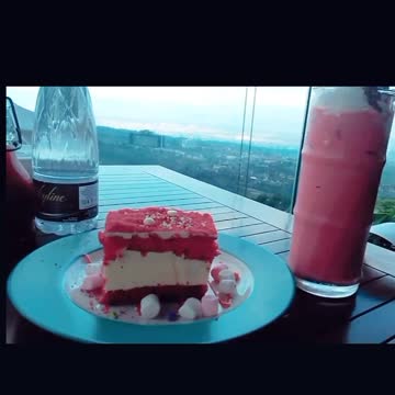 Enjoy the beautiful view at the cafe with red velvet cake and strawberry milkshake