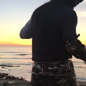 Guy in black and white camo with mask on skates by