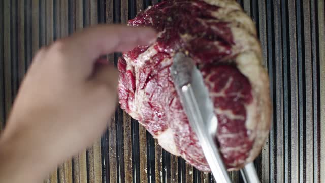 flipping-a-steak-in-a-pan-grill