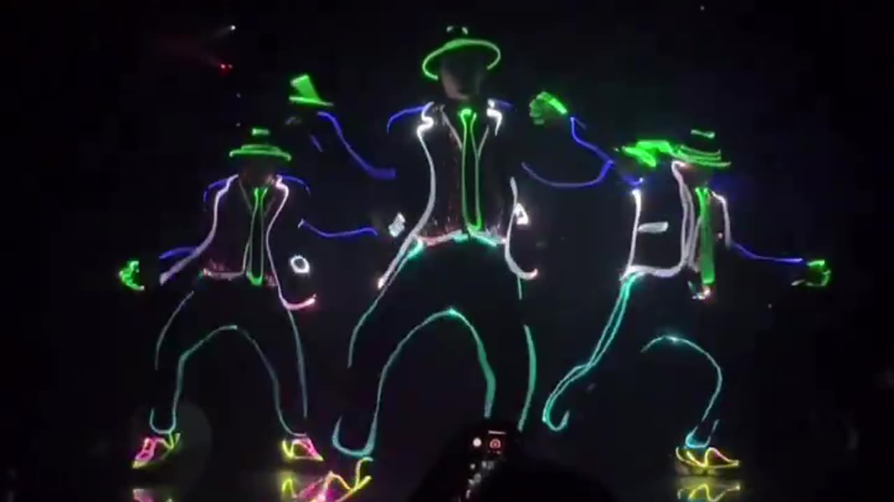 Mesmerizing Dance Routine: Performer Plays and Fools Around with Laser Light