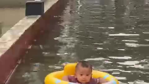 baby swimming in the river