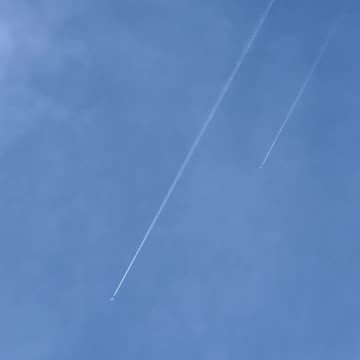 Why do airplanes leave a trail of white smoke?