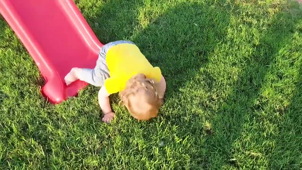 Funny babies playing slide falls