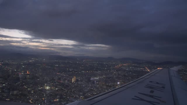 Plane flying over a city at night