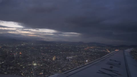 Plane flying over a city at night