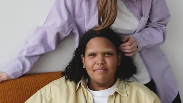 A Woman Fixing Her Partner's Hair