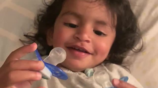 Adorable toddler has fun sucking on two pacifiers at a time! So funny!!