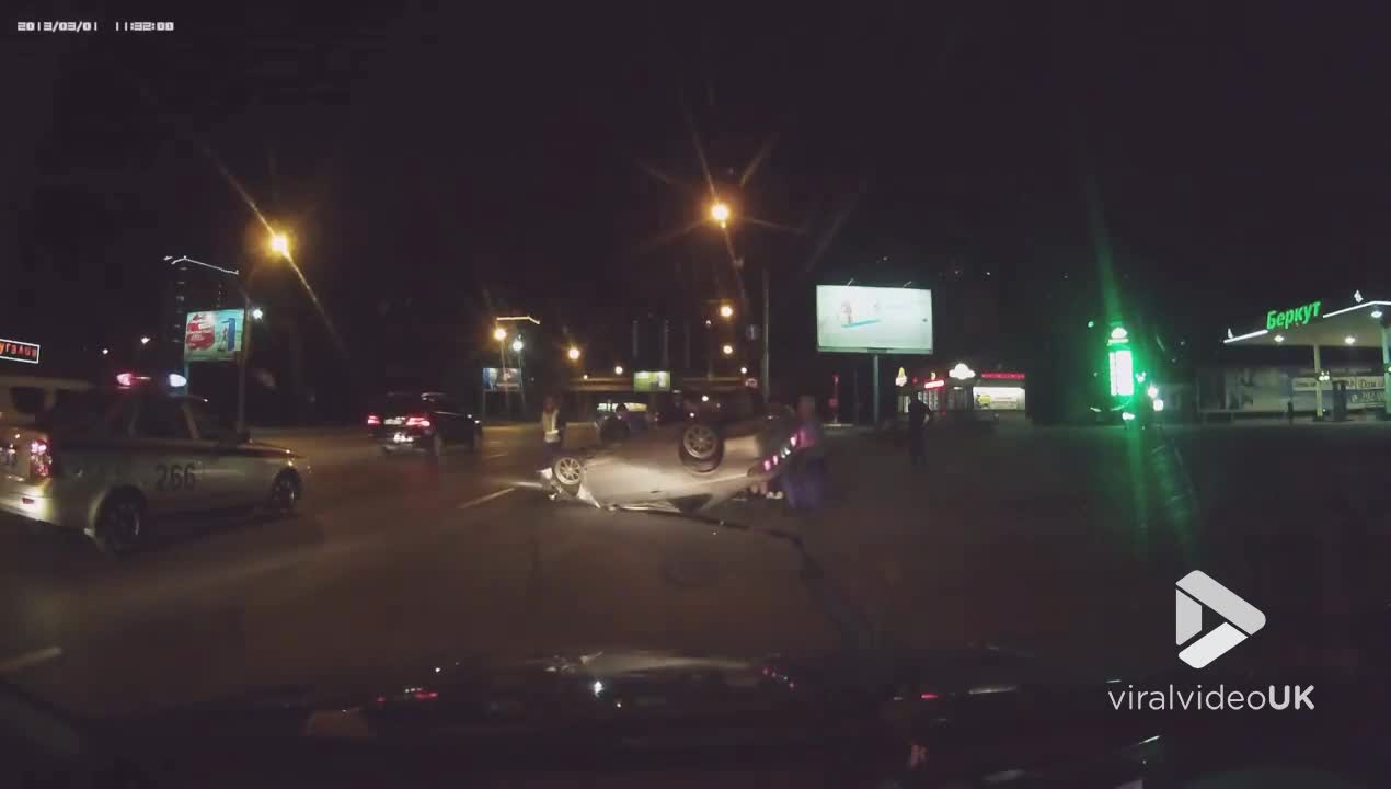 Upturned car slides down busy road