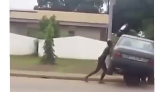 Pushing a dead car on a wheelbarrow